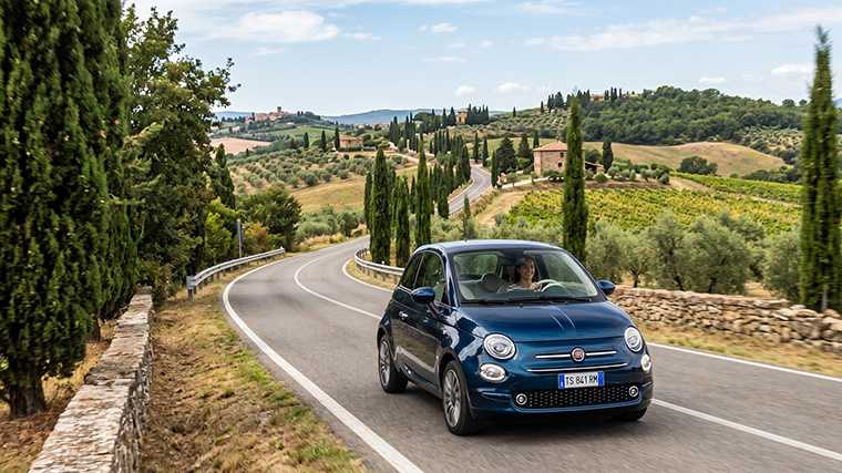 Een Fiat 500 op een typisch Italiaanse weg.
