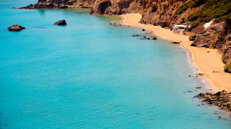 De door rotsen beschutte strandjes van Aigües Blanques, Ibiza.