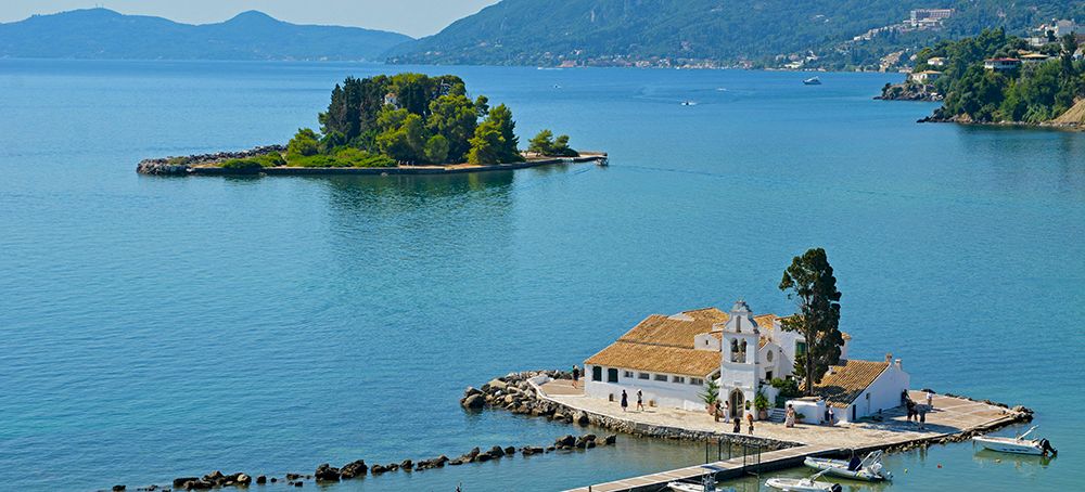 Het iconische klooster Vlachérna met daarachter het Muizeneiland bij Corfu-Stad.